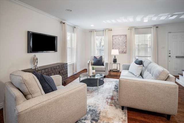 living room with dark wood-type flooring and ornamental molding