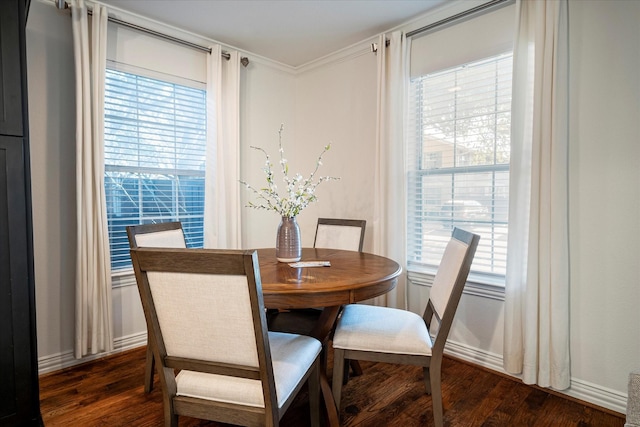 dining room with crown molding and dark hardwood / wood-style floors