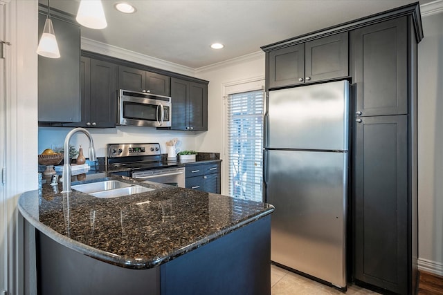 kitchen featuring sink, crown molding, hanging light fixtures, dark stone countertops, and stainless steel appliances