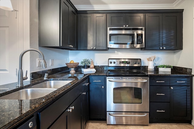 kitchen with crown molding, appliances with stainless steel finishes, sink, and dark stone counters