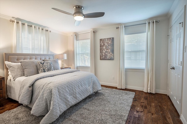 bedroom with dark wood-type flooring, ceiling fan, and crown molding