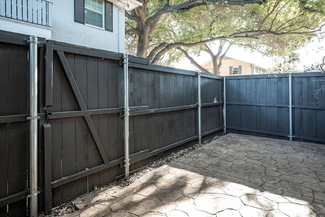 view of gate featuring a patio