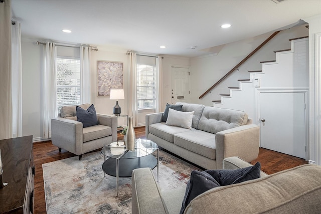 living room featuring dark hardwood / wood-style floors and a healthy amount of sunlight