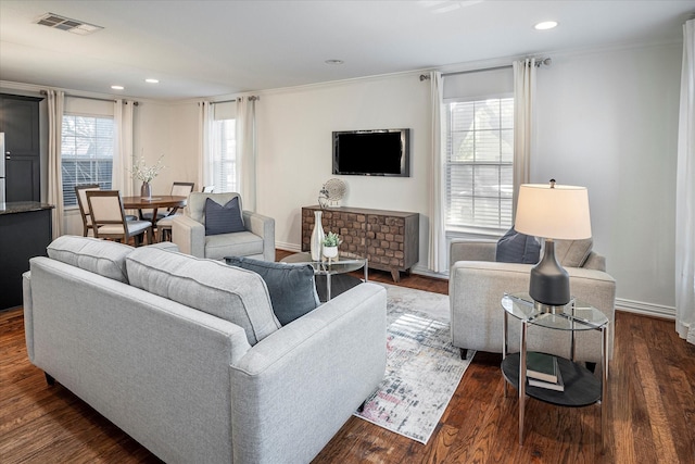 living room featuring crown molding and dark hardwood / wood-style floors