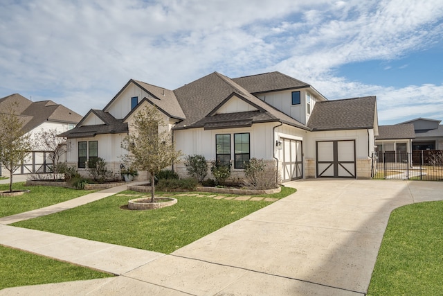 view of front facade with a garage, fence, a front yard, roof with shingles, and concrete driveway