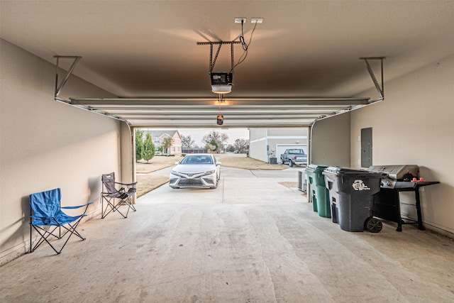 garage with a garage door opener and electric panel