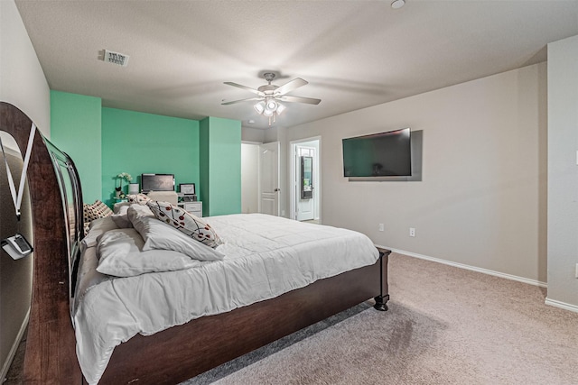 carpeted bedroom featuring a textured ceiling and ceiling fan