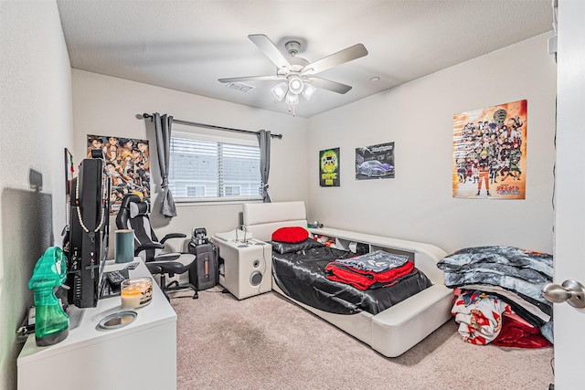 bedroom with ceiling fan and light carpet