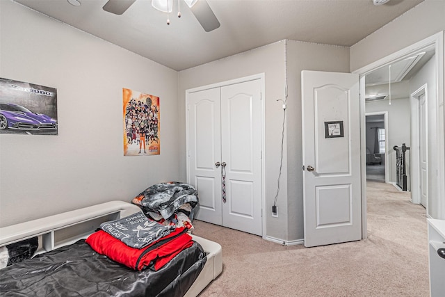 bedroom with ceiling fan, carpet floors, and a closet