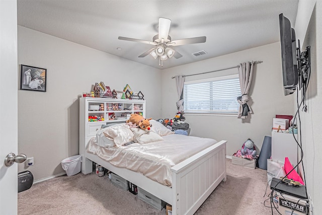 bedroom with ceiling fan and light colored carpet