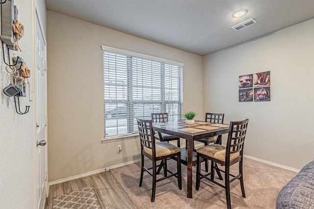 dining space with light hardwood / wood-style floors