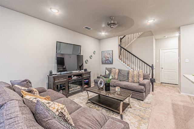 carpeted living room featuring ceiling fan