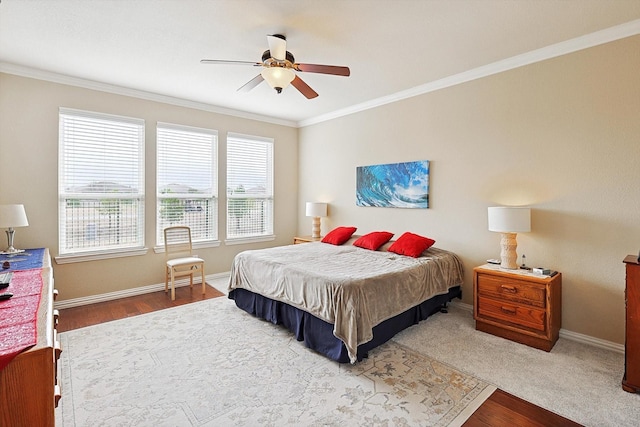 bedroom featuring ornamental molding, wood-type flooring, and ceiling fan