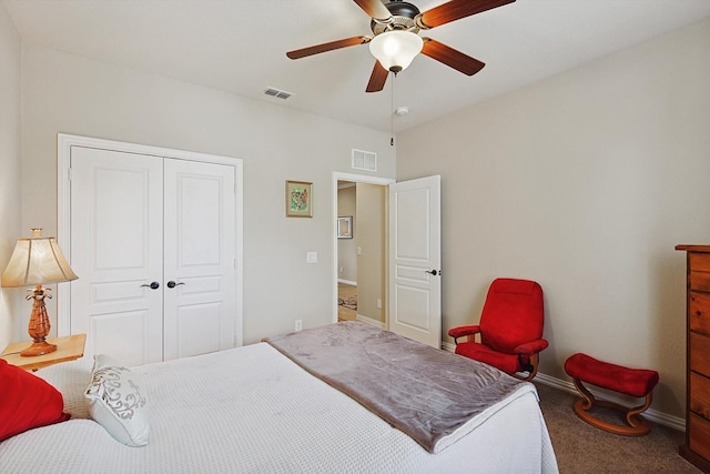 carpeted bedroom with ceiling fan and a closet