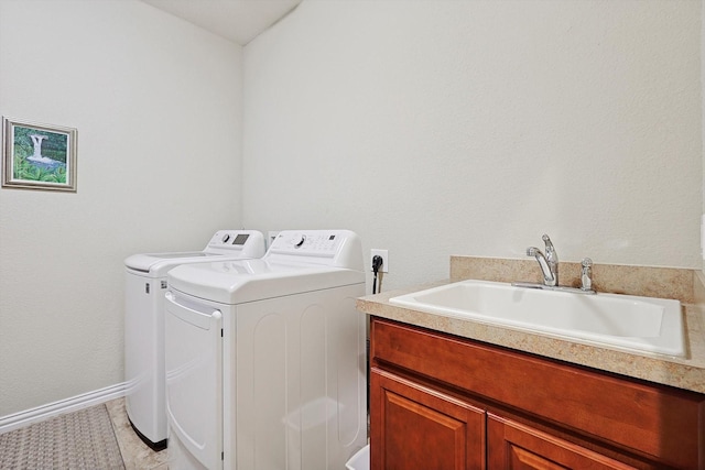 clothes washing area featuring separate washer and dryer, sink, light tile patterned floors, and cabinets