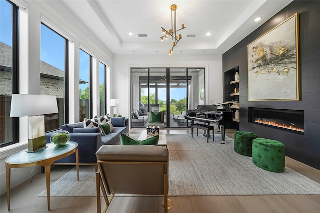 building lobby with a raised ceiling and hardwood / wood-style flooring