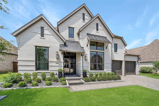 view of front of property with a front yard and a garage