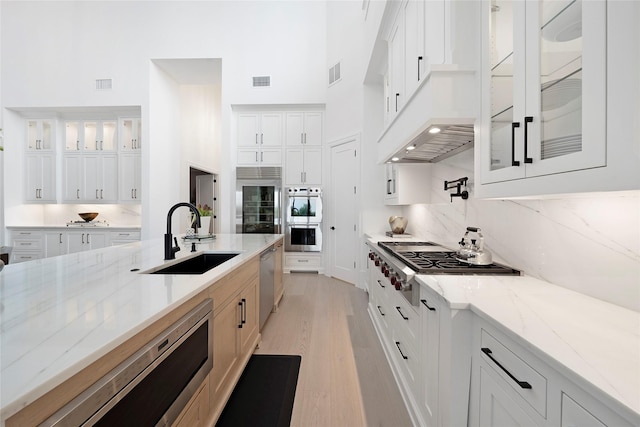 kitchen featuring sink and white cabinets