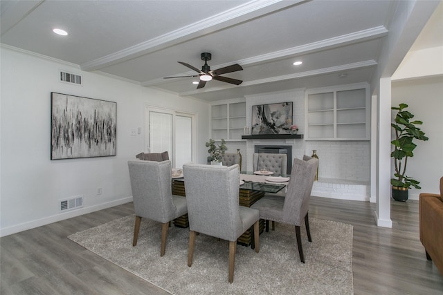 dining area with hardwood / wood-style flooring, ornamental molding, ceiling fan, and beam ceiling