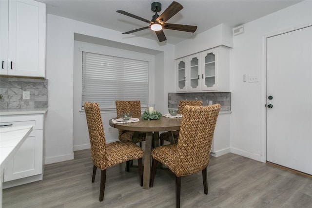 dining area with ceiling fan and light hardwood / wood-style flooring