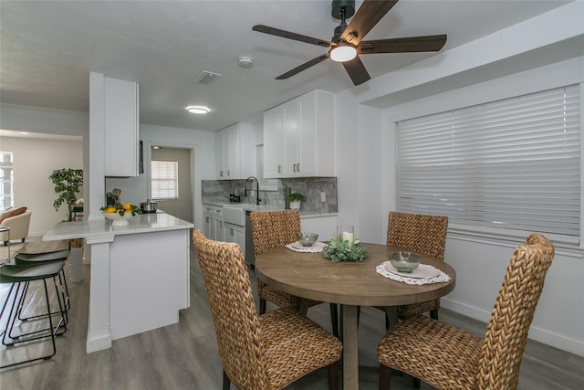 dining space with dark hardwood / wood-style floors and ceiling fan