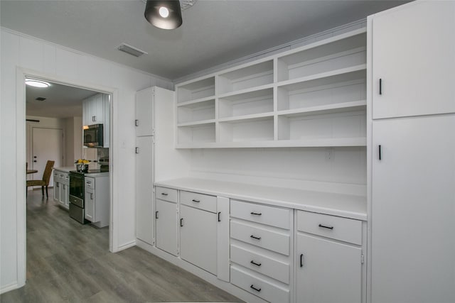 kitchen featuring white cabinetry, crown molding, light hardwood / wood-style floors, and appliances with stainless steel finishes