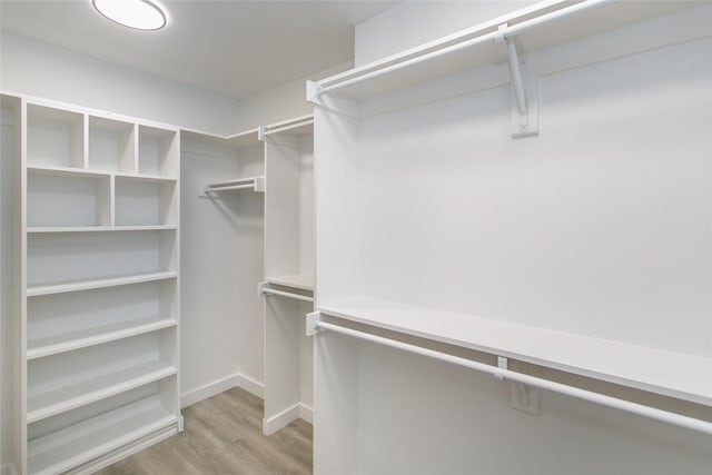 walk in closet featuring light hardwood / wood-style floors