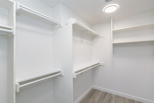 spacious closet featuring hardwood / wood-style floors