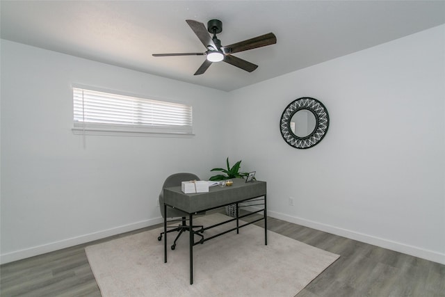 office with wood-type flooring and ceiling fan