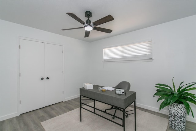 office with ceiling fan and light hardwood / wood-style floors