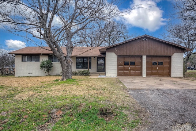 ranch-style home featuring a garage and a front yard