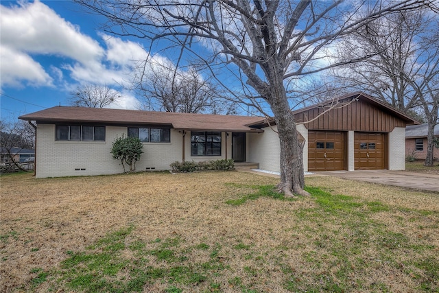 ranch-style house with brick siding, a front yard, a garage, crawl space, and driveway