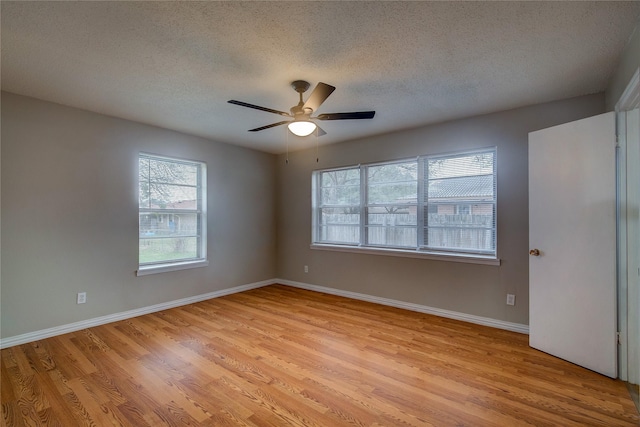 unfurnished room with a textured ceiling, ceiling fan, and light wood-type flooring