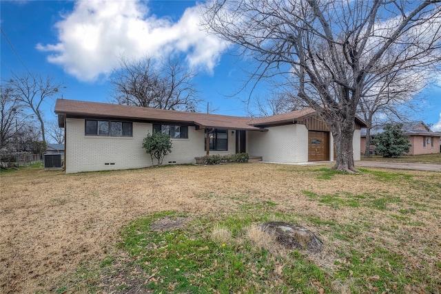 single story home with cooling unit, a garage, and a front yard