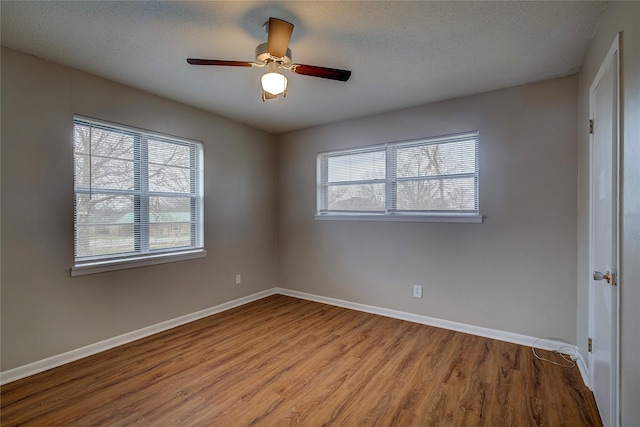 unfurnished room featuring ceiling fan, light hardwood / wood-style floors, and a textured ceiling