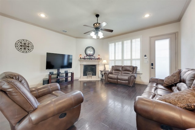 living room with a high end fireplace, ornamental molding, dark hardwood / wood-style floors, and ceiling fan