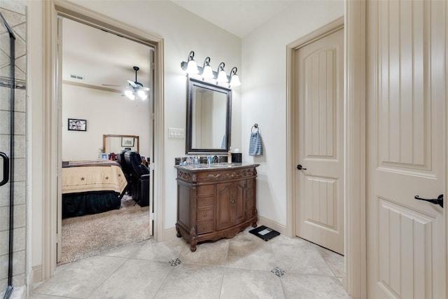 bathroom featuring tile patterned flooring, vanity, ceiling fan, and walk in shower