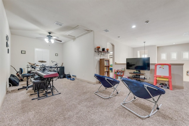 exercise area featuring ceiling fan and carpet flooring