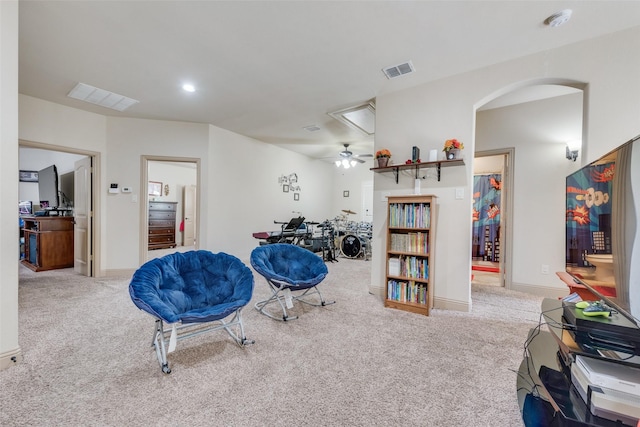 interior space featuring ceiling fan and light colored carpet