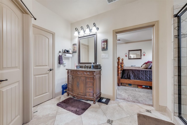 bathroom with vanity, an enclosed shower, and tile patterned floors