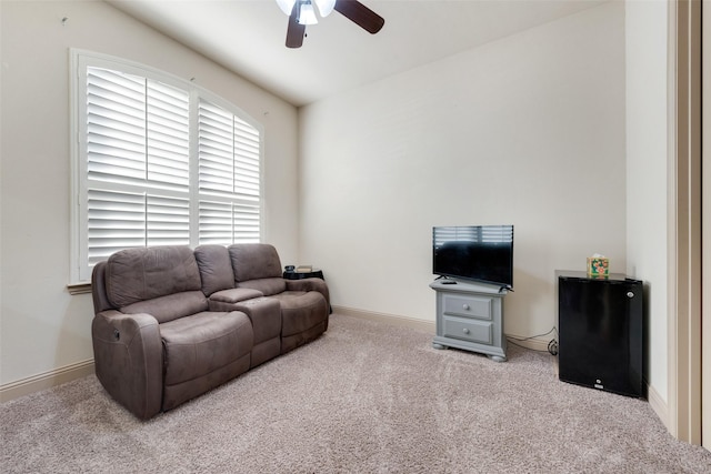 living room featuring light colored carpet and ceiling fan