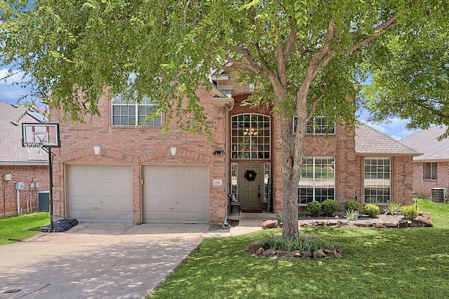 view of front of house with central AC, a garage, and a front yard