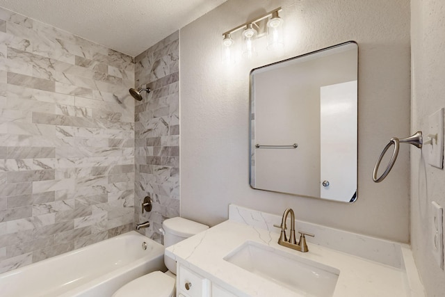 full bathroom featuring tiled shower / bath, vanity, a textured ceiling, and toilet