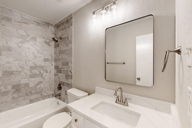 full bathroom featuring vanity, toilet, tiled shower / bath combo, and a textured ceiling