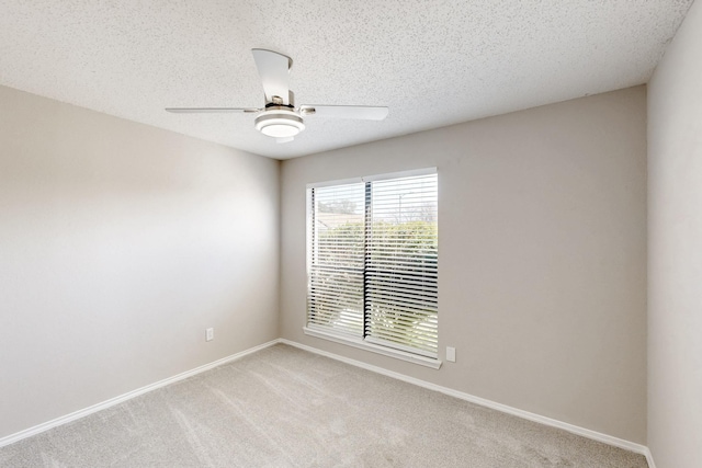 carpeted spare room with ceiling fan and a textured ceiling