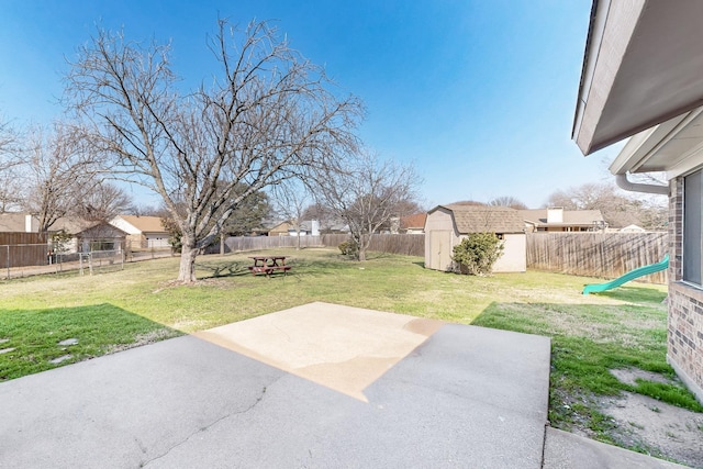 view of yard with a storage shed and a patio