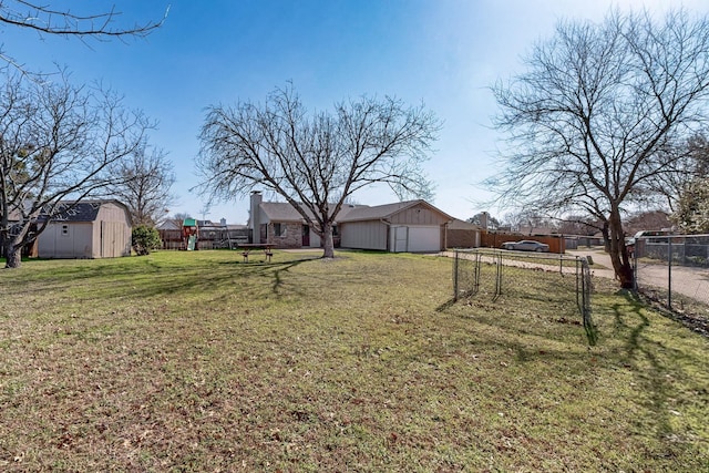 view of yard with a storage shed and a playground