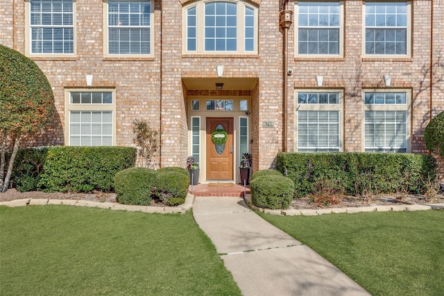 entrance to property with a lawn