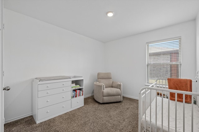 bedroom with carpet and a crib