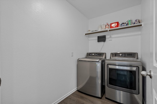 clothes washing area featuring dark wood-type flooring and washer and dryer